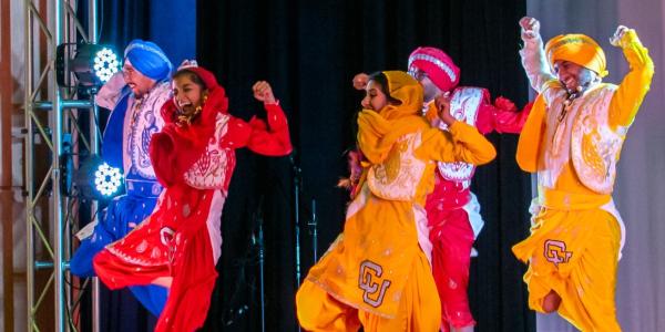 Students in costume dancing on international festival day