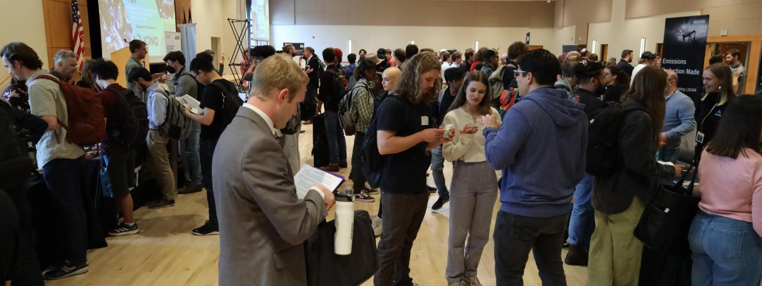 Students are pictured talking with employers at the Physics Career Fair