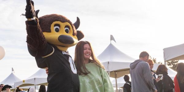 Ralphie mascot posing with student on admitted student day