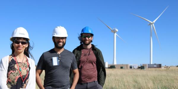 Researchers in front of hurricane-resilient wind turbines