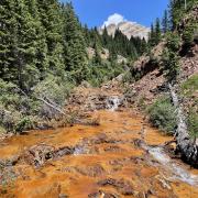 Iron oxides stain the bed of Upper East Mancos River in southwestern Colorado
